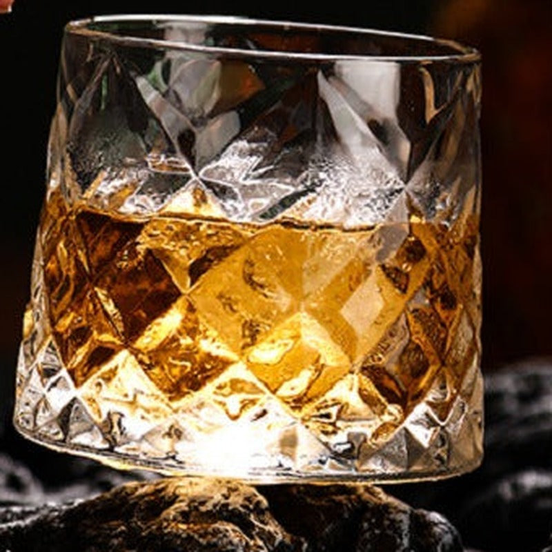Diamond cut spinning whiskey glass with bourbon