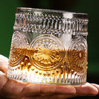 Heritage embossed spinning whiskey glass held in hand